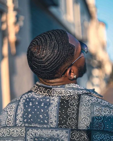 Back view of a man rocking 360 Waves with Fade
