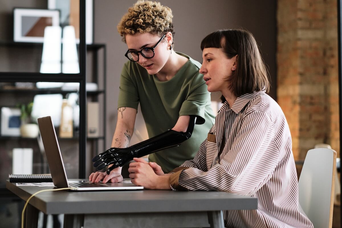 Co-workers looking at a laptop