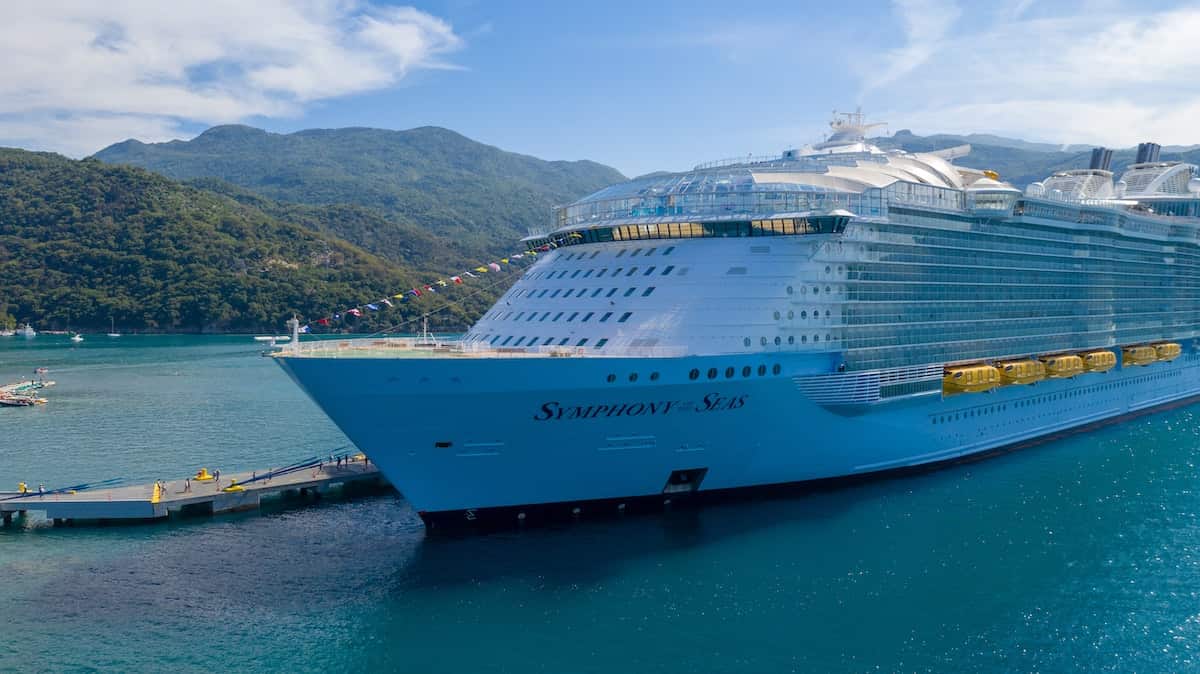 white cruise ship docked beside port