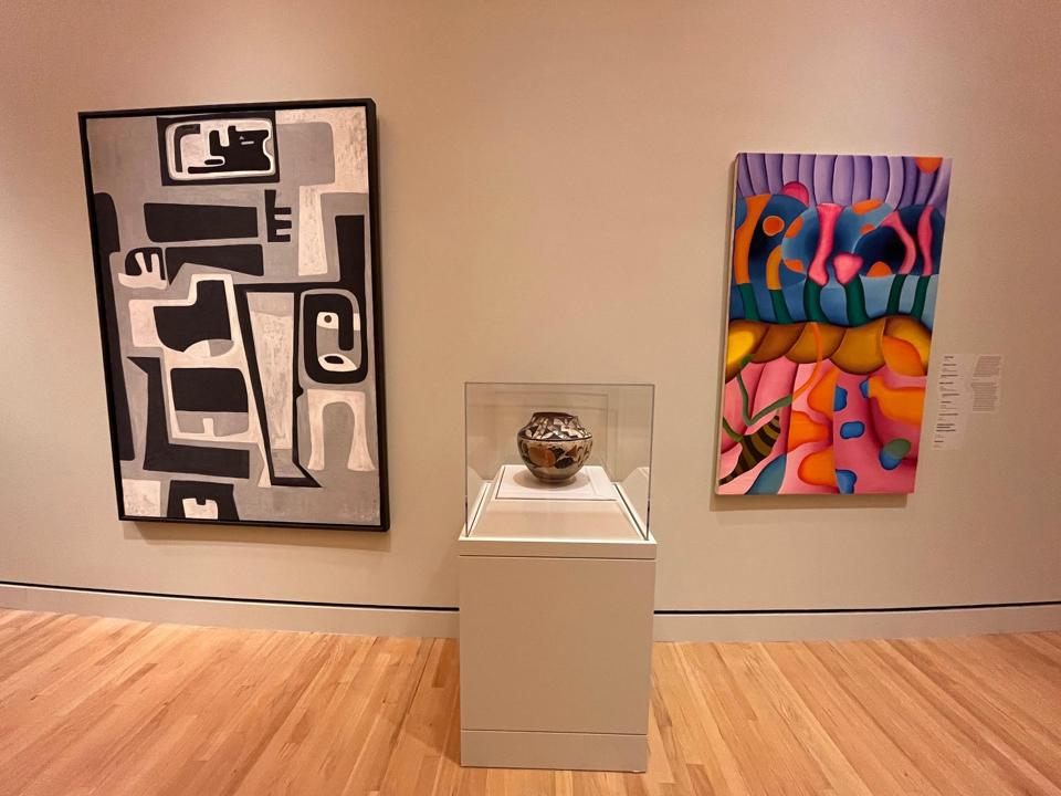 “Space Makers: Indigenous Expression and a New American Art” installation view at the Crystal Bridges Museum of American Art; left to right, Peter Busa painting ca. 1948, Pueblo water jar ca. 1900, Linda Lomahaftewa (Hopi/Choctaw; b. 1947) painting from late 1960s.