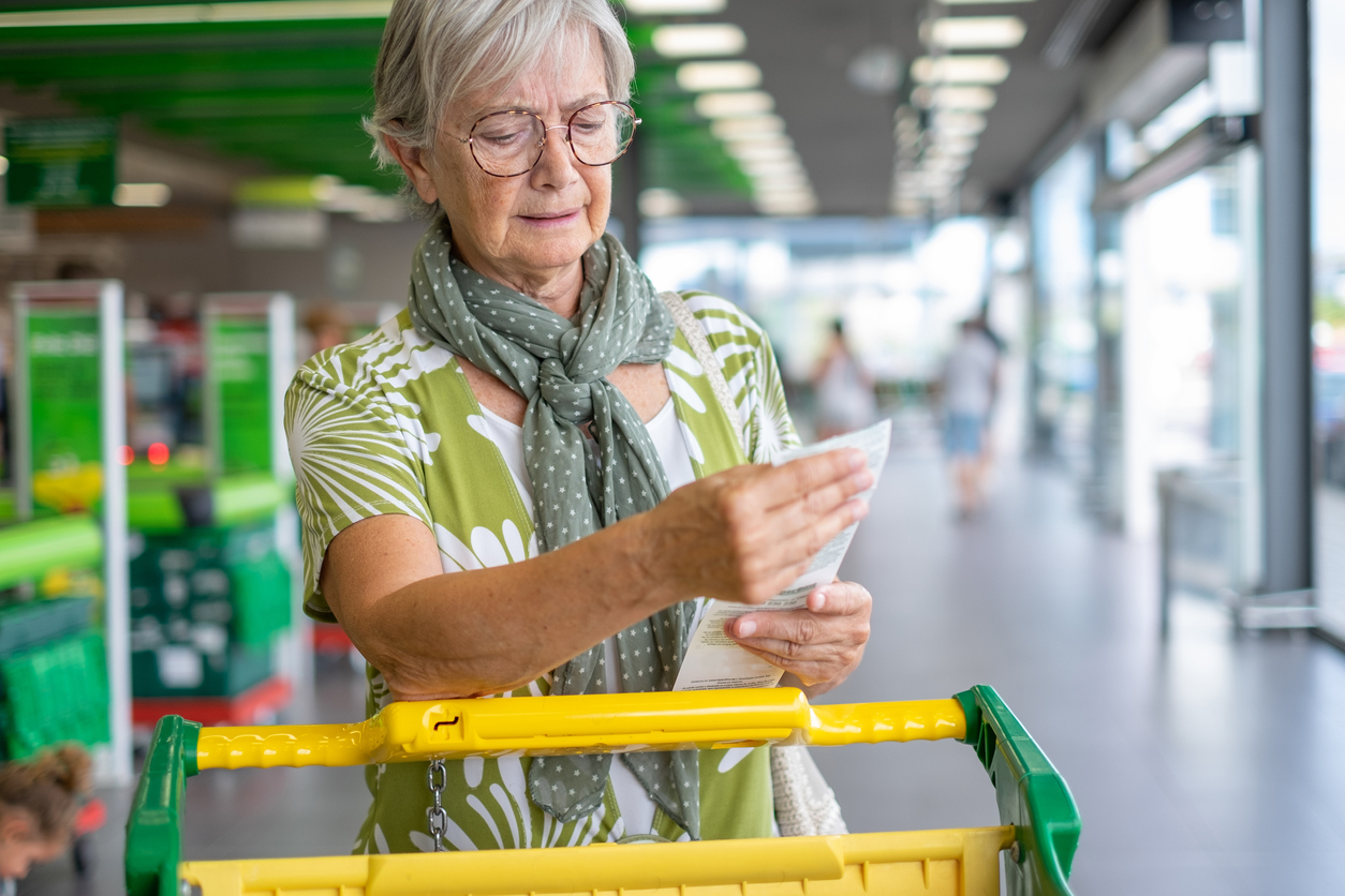 senior looking at receipt