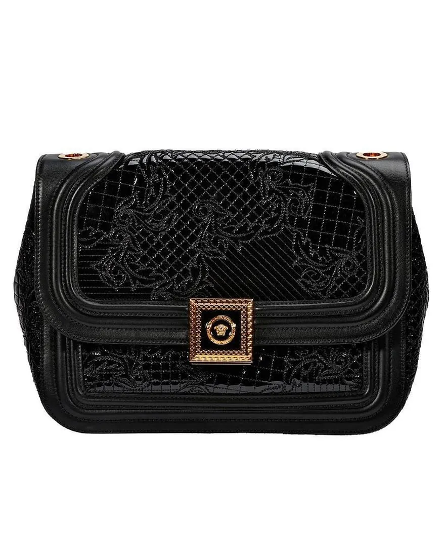 A black purse with gold accents

Description automatically generated