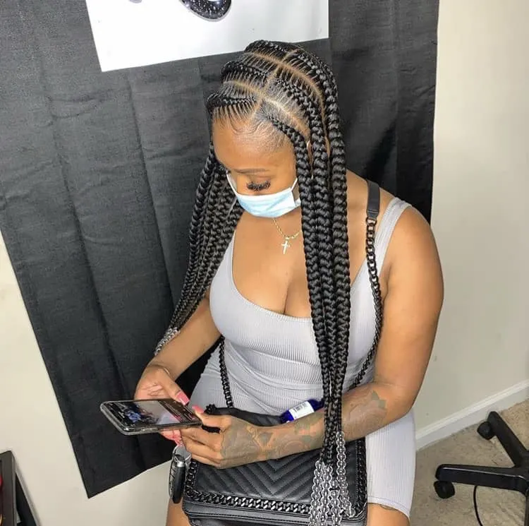Picture of a lady wearing the pop smoke braids with clear beads