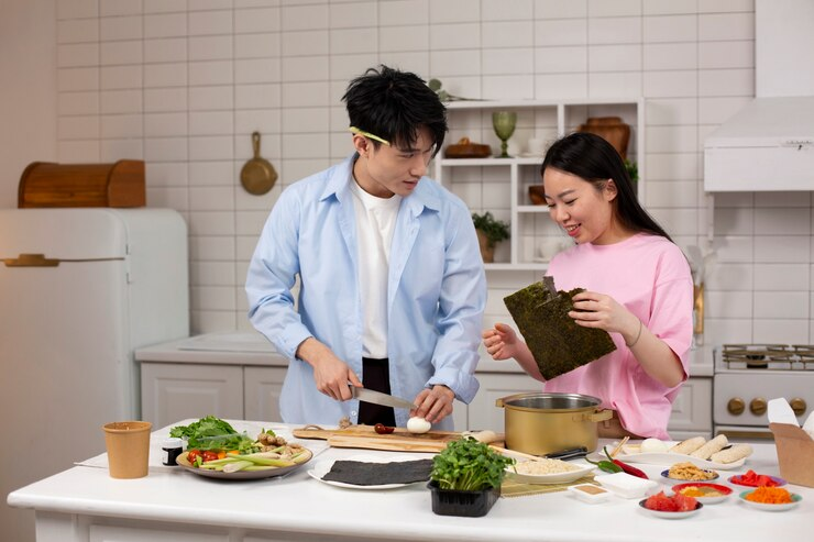 dua orang sedang memasak di dapur