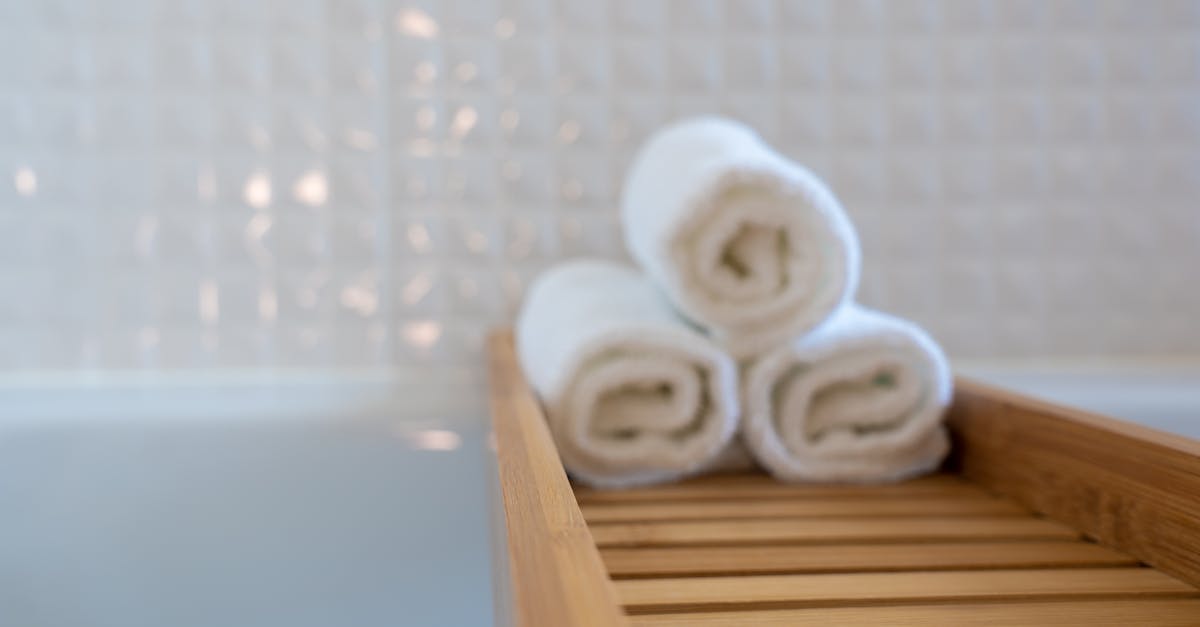 Three Towels on Brown Wooden Rack