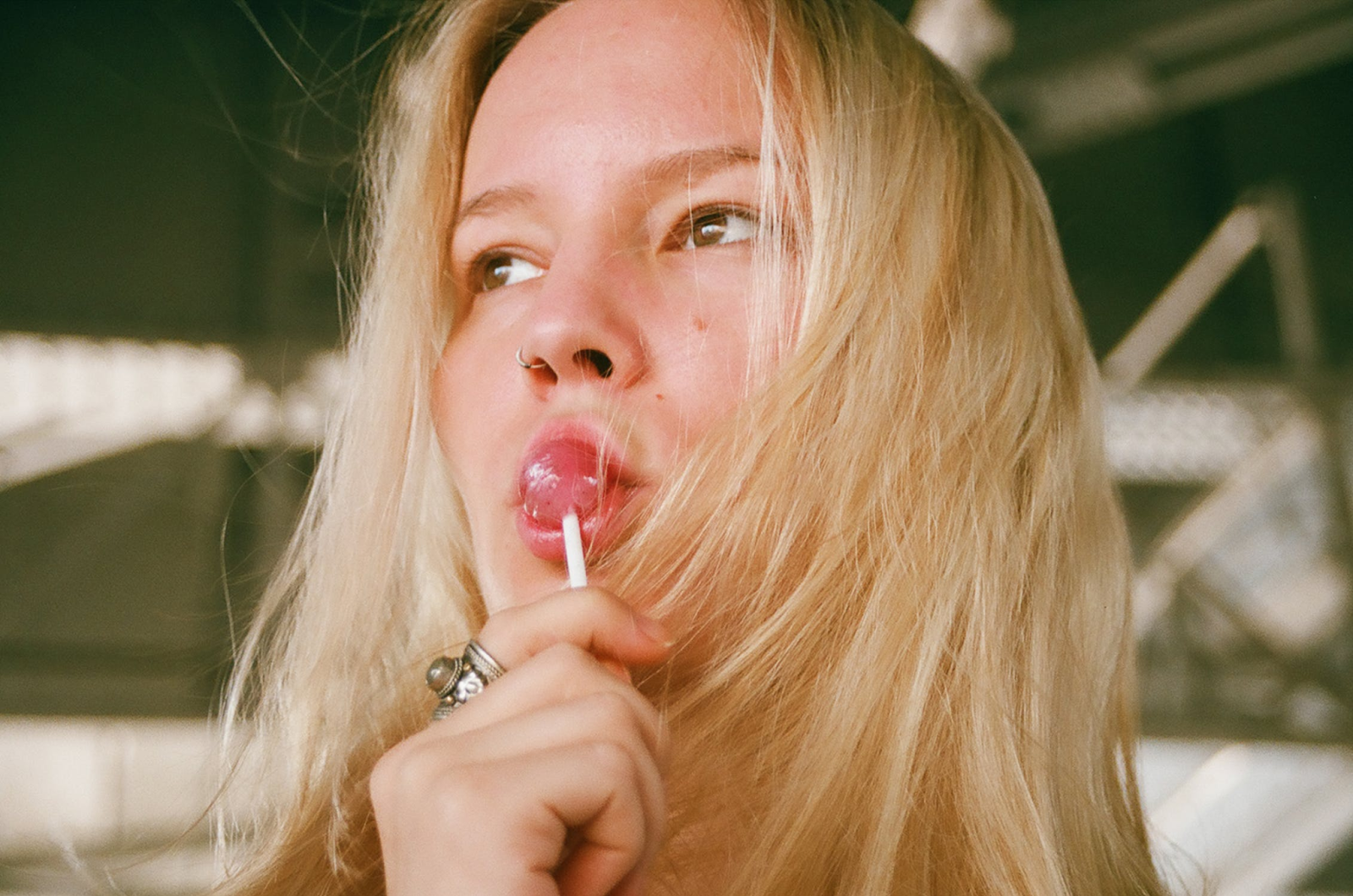 A woman sucking on a lollipop