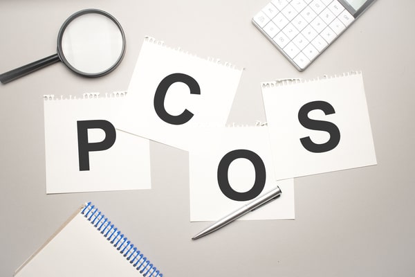 Pieces of paper spelling out the word "PCOS"