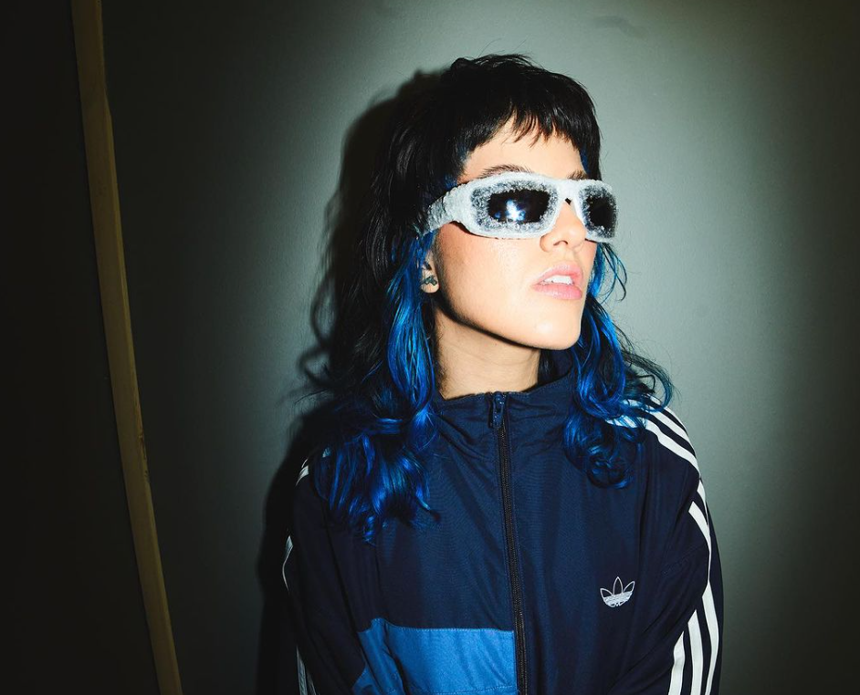 Paopao, a 2024 Grammy nominee from Puerto Rico, in an Adidas jacket and glitter sunglasses.
