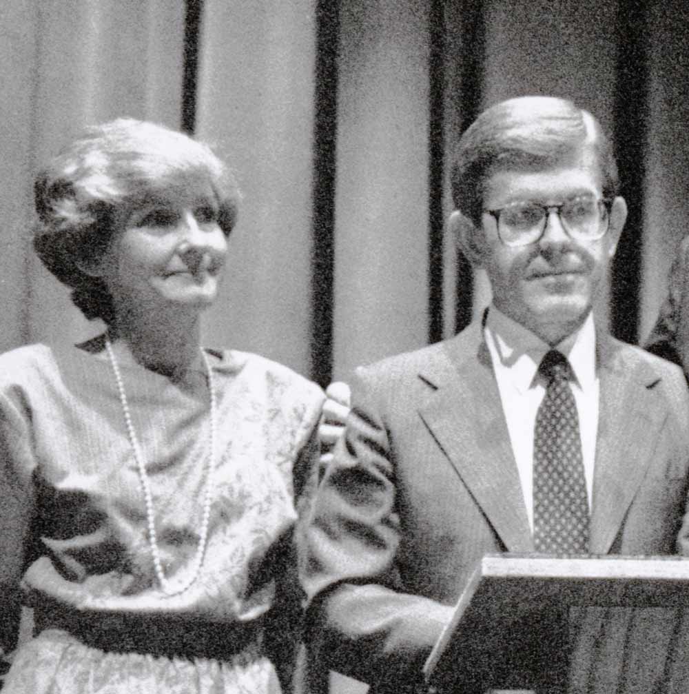Sister Hafen, in a church dress and a pearl necklace, standing next to her husband when he was President of Ricks College.