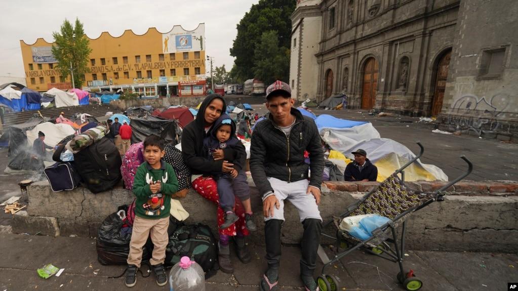 Gia đình Aguilar Bastida, đến từ Venezuela, ngồi bên ngoài Nhà thờ Santa Cruz y La Soledad nơi các di dân cắm trại tại Mexico City, ngày 26/12/2023.
