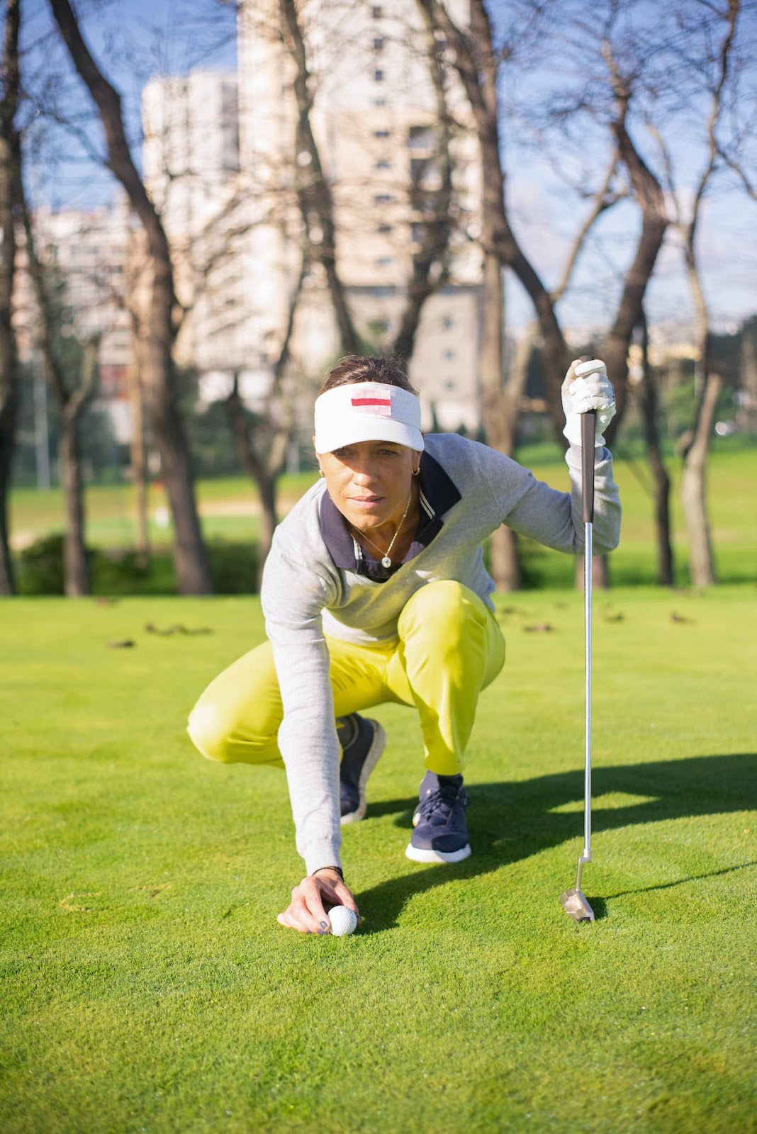 Female golfer looking at her target as she golfs during winter