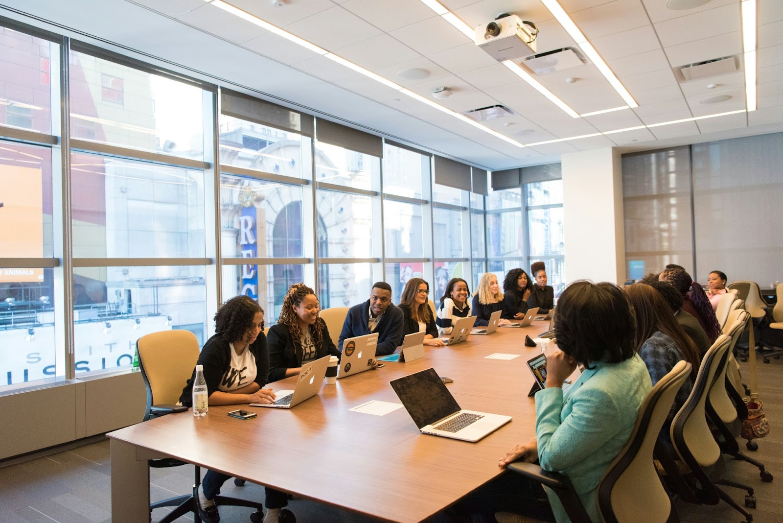 A group of professionals gathered around a conference table during a training session.