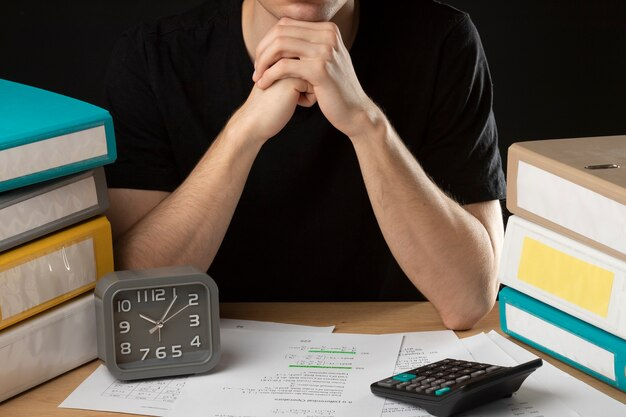 Image of a clock and stressed student with the text 'Hard Exams.'
