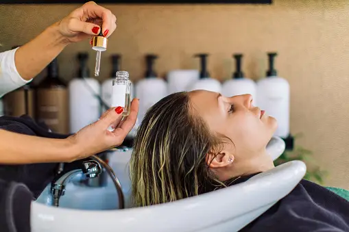 Woman Getting Her Hair Treated in Hair Salon