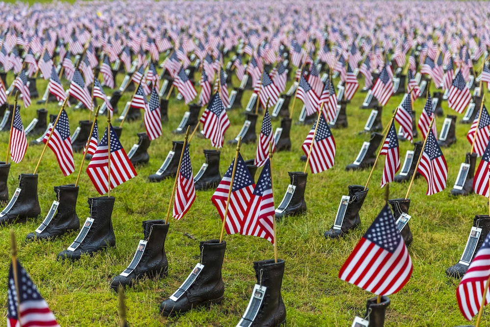 Boots of Martyred Soldiers With U.S. Flags in Them