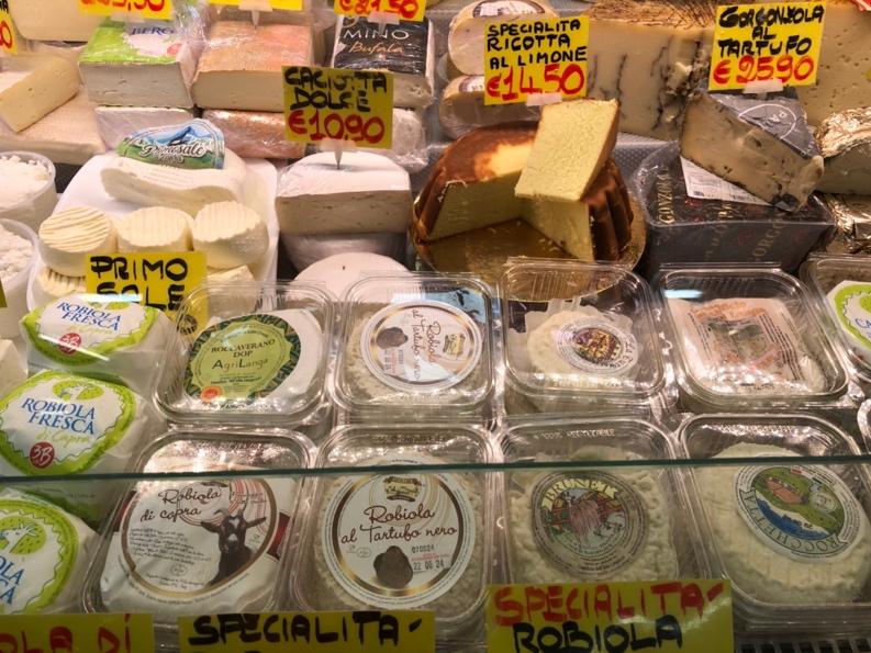 A display case with different types of cheese

Description automatically generated