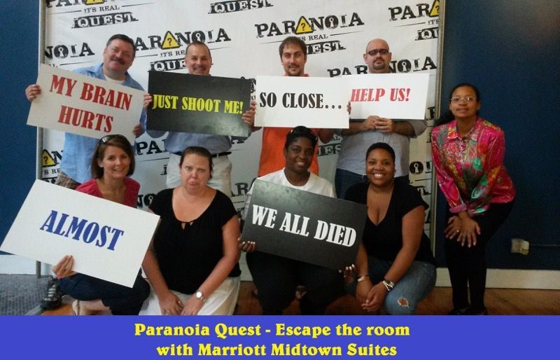 A team holding banners and celebrating success after winning a escape game. 