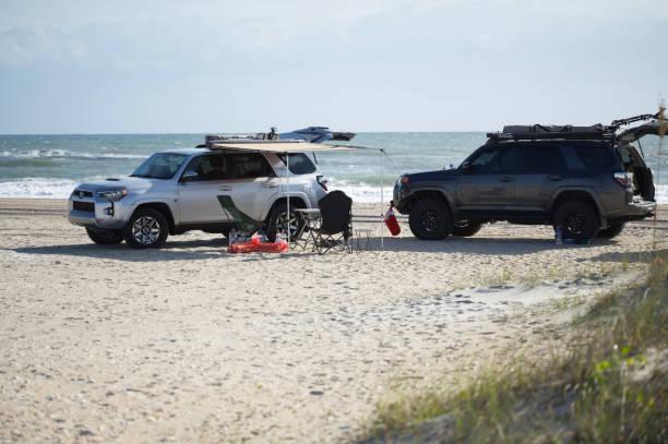 Overland camping on the beach with 4Runners Davis, North Carolina - November 24, 2022: Two Toyota 4Runners camping on the beach of Cape Lookout National Seashore in Davis, North Carolina. car awning stock pictures, royalty-free photos & images