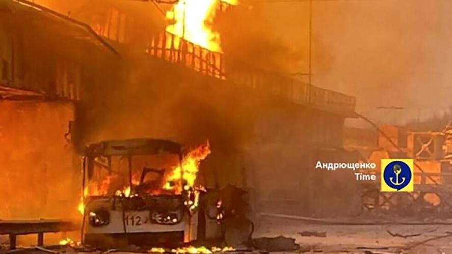 In this photo provided by Petro Andryuschenko, the adviser of the head of Mariupol city's administration, burning trolleybus is seen on the damp of hydroelectric power station after Russian attacks in