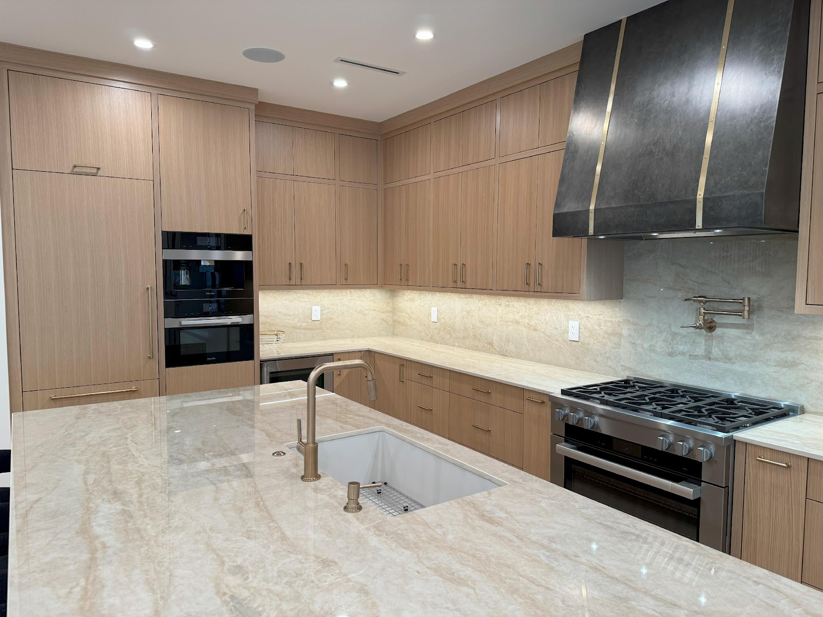 A kitchen with a marble countertop
