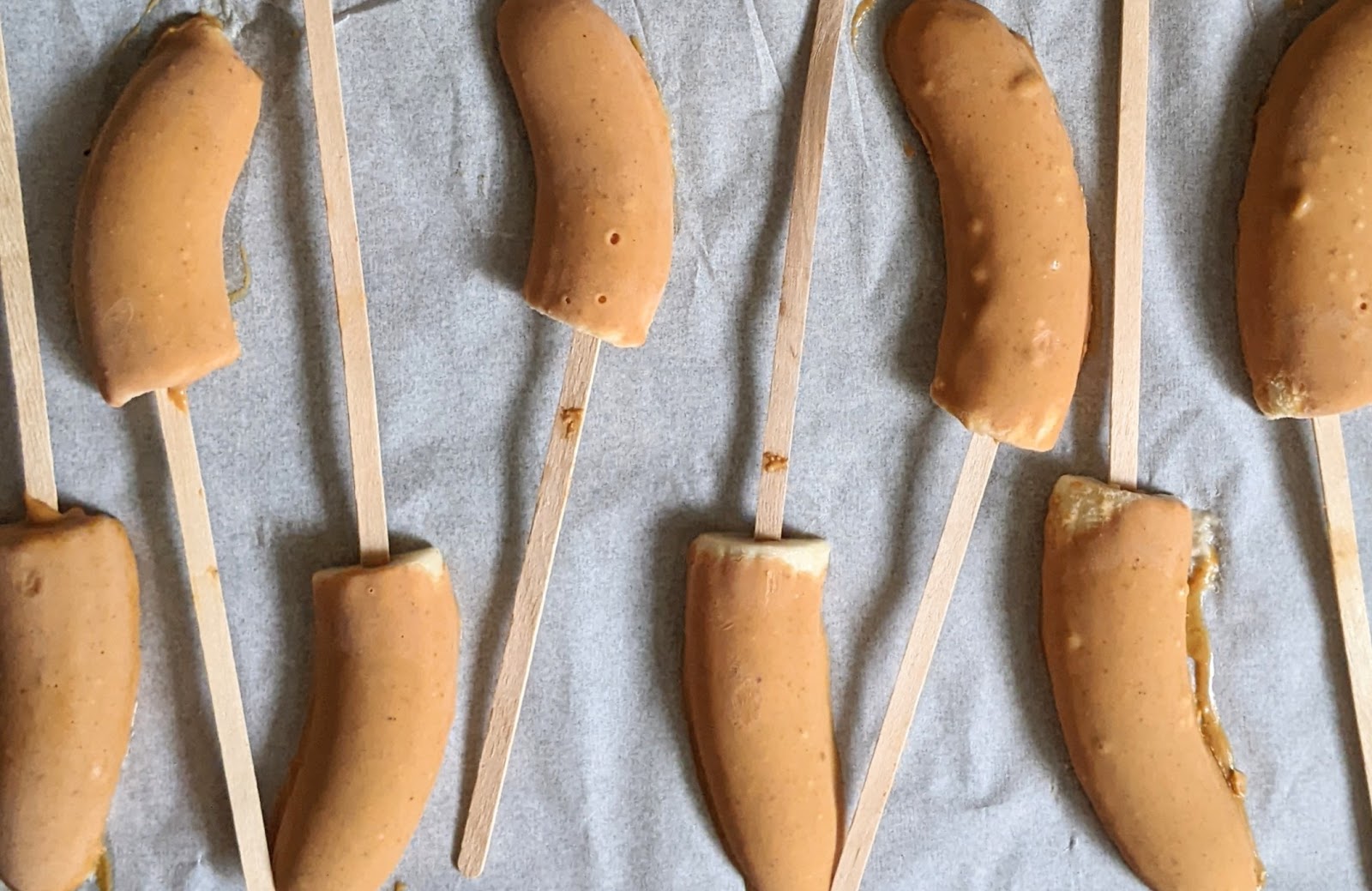 top down view of frozen bananas covered in melted peanut butter