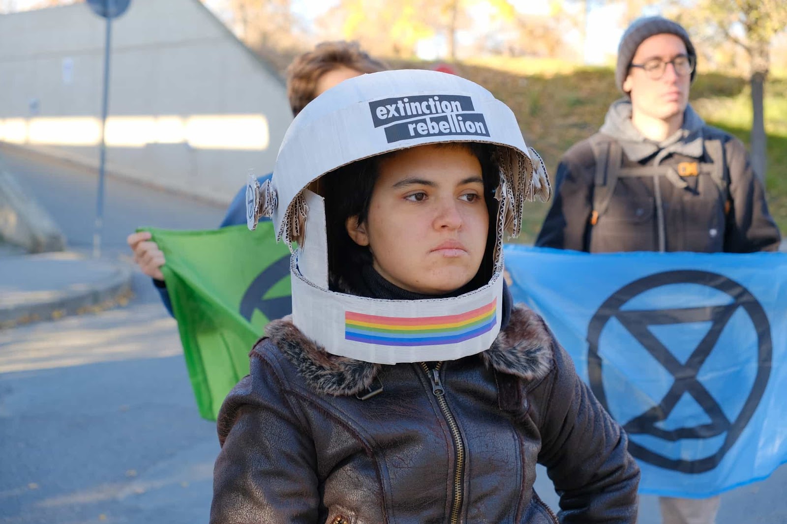A rebel wears a homemade astronaught helmet with XR insignia and rainbows
