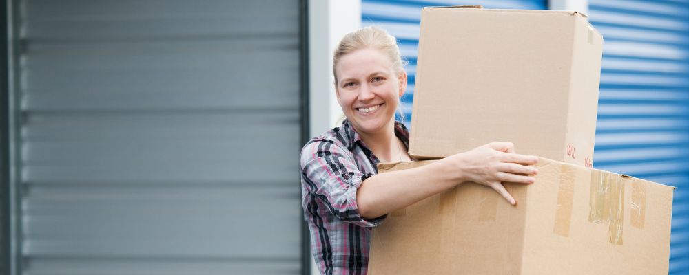 A smiling person inside a Wigwam self storage unit
