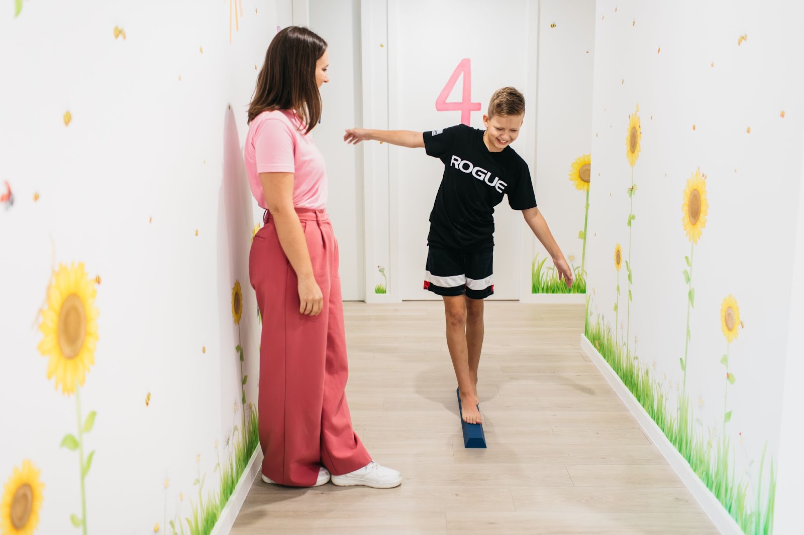 Child balancing on a beam in an Occupational therapy session