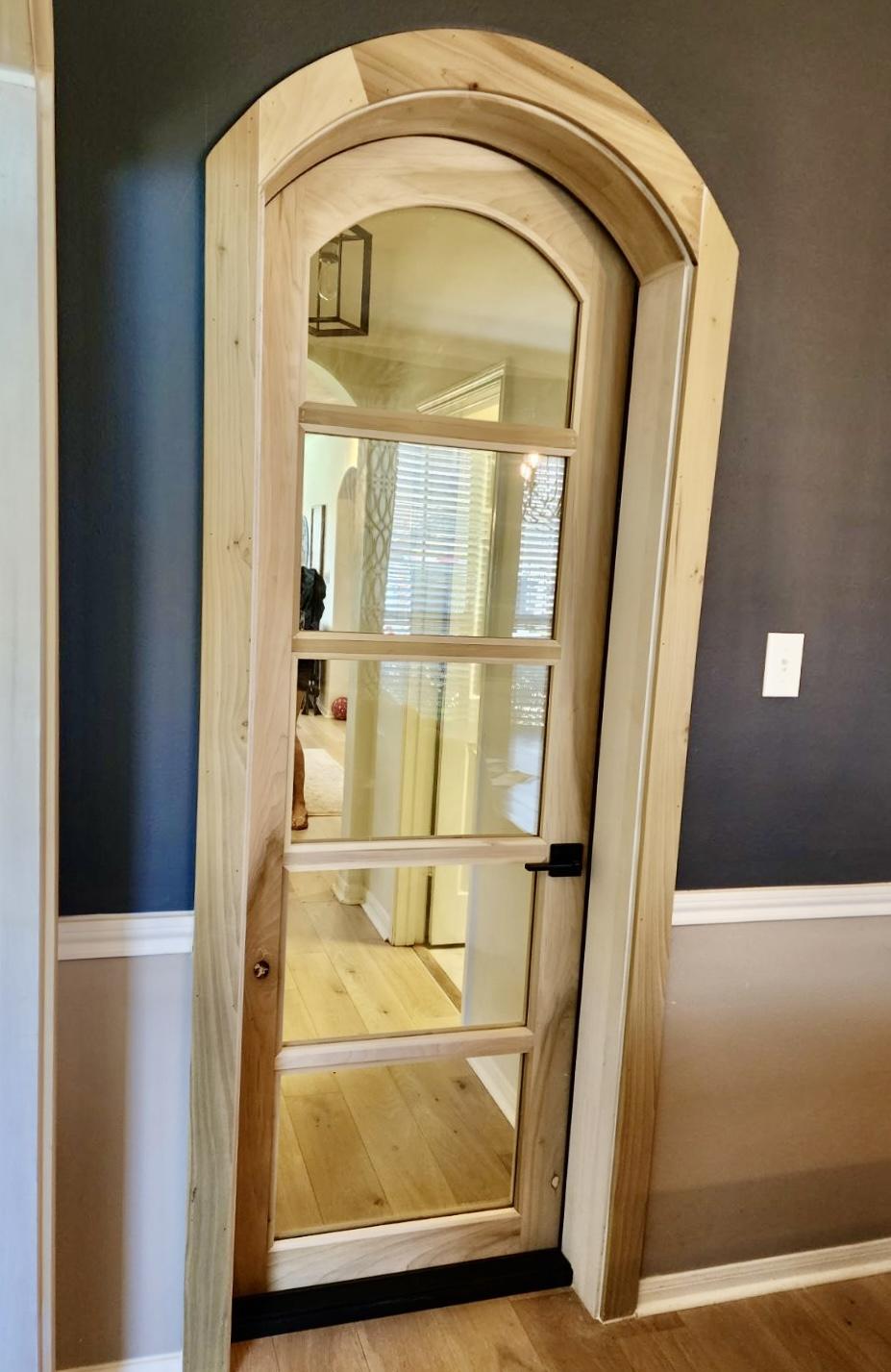 A door with a mirror

Description automatically generated