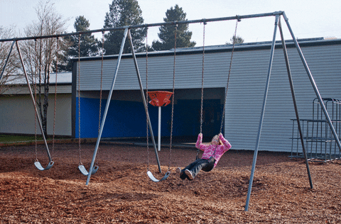 Girl in Pink Shirt On a Swing
