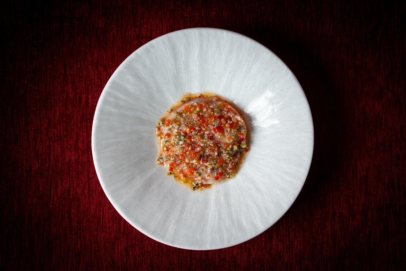 A plate of food on a red surface

Description automatically generated