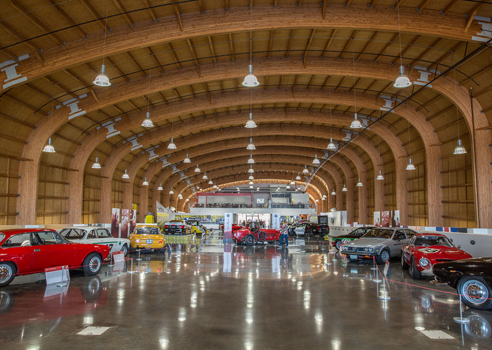 Vintage automobiles in large hall.