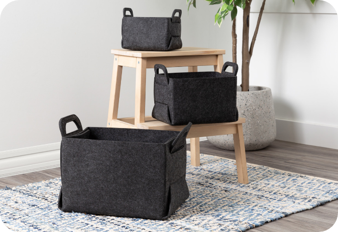 Our dark grey Collapsible Felt Baskets displayed in a room.