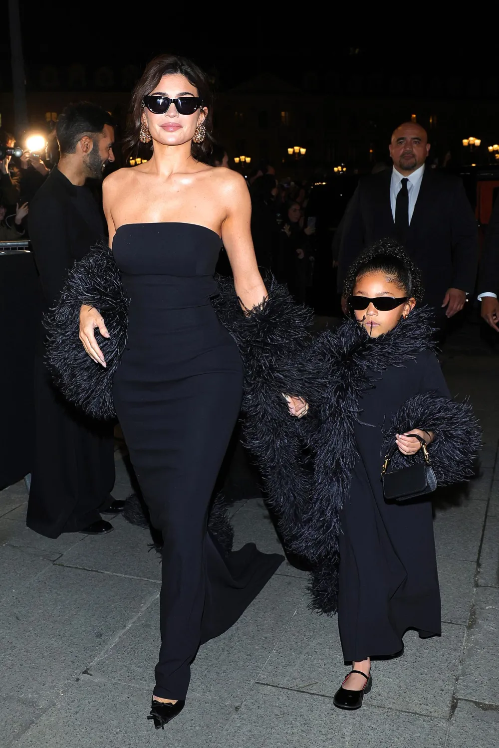 Picture showing Kylie Jenner accompanied by Stormi webster  in their stunning black gown with faux fur