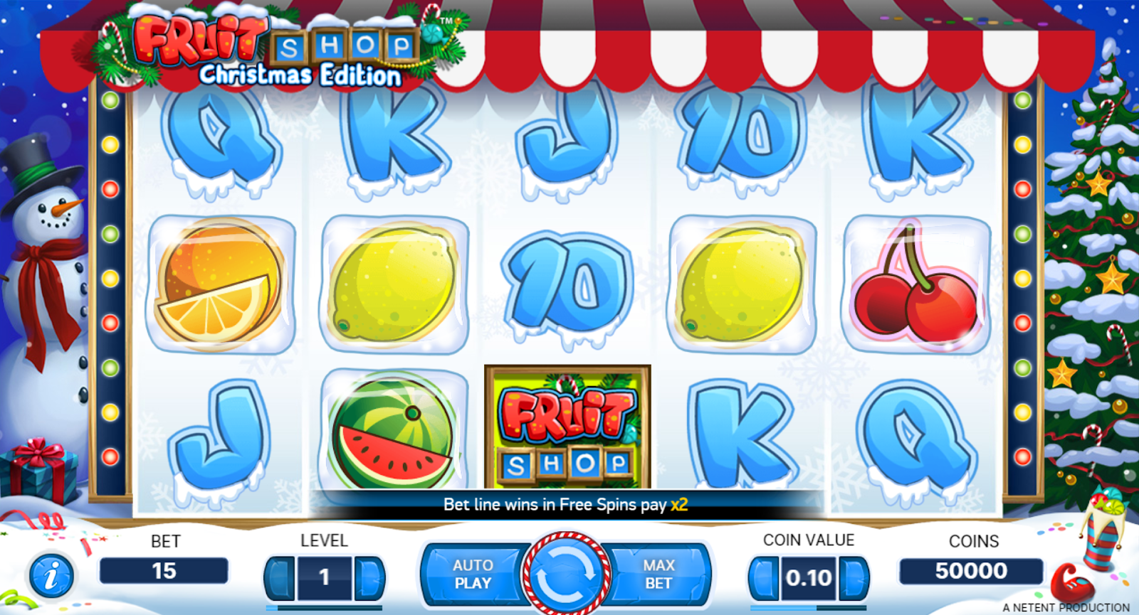 A screen shot of a slot game with frozen fruits in a christmas background with a snow man and christmas tree.

