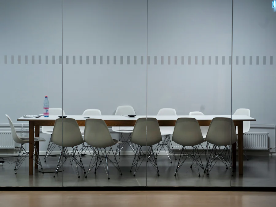 Board room with glass doors (https://unsplash.com/photos/long-table-with-eiffel-chair-inside-room-ULh0i2txBCY)