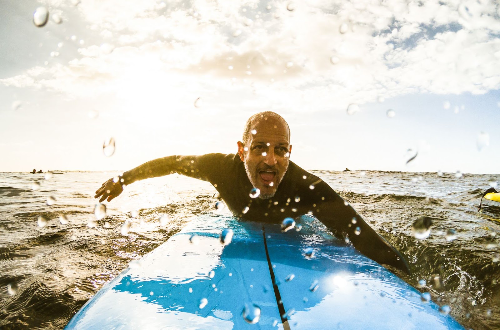 Man paddling on a surfboard. 