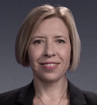 A person with short blonde hair

Description automatically generated