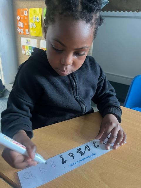 A child writing on a piece of paper

Description automatically generated