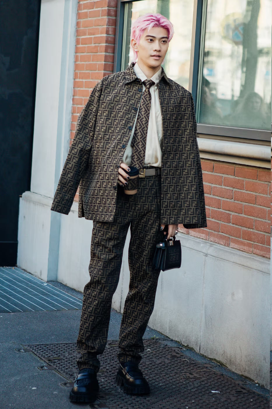 Picture showing a guy with pink hair rocking a fendi suit and tie for the event