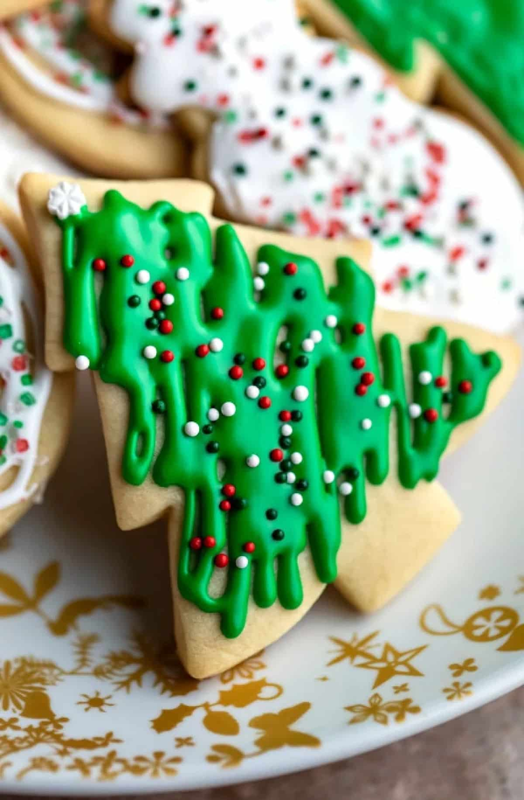 christmas cookie recipes in the shape of christmas trees with green icing and sprinkles 
