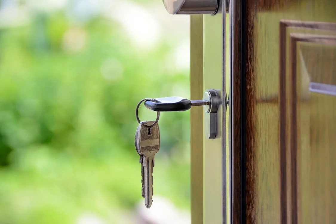 A close up of house keys being used to open a door