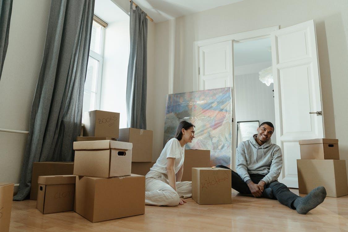 Free Man in Gray Long Sleeve Shirt Sitting Beside Woman in White Long Sleeve Shirt Stock Photo