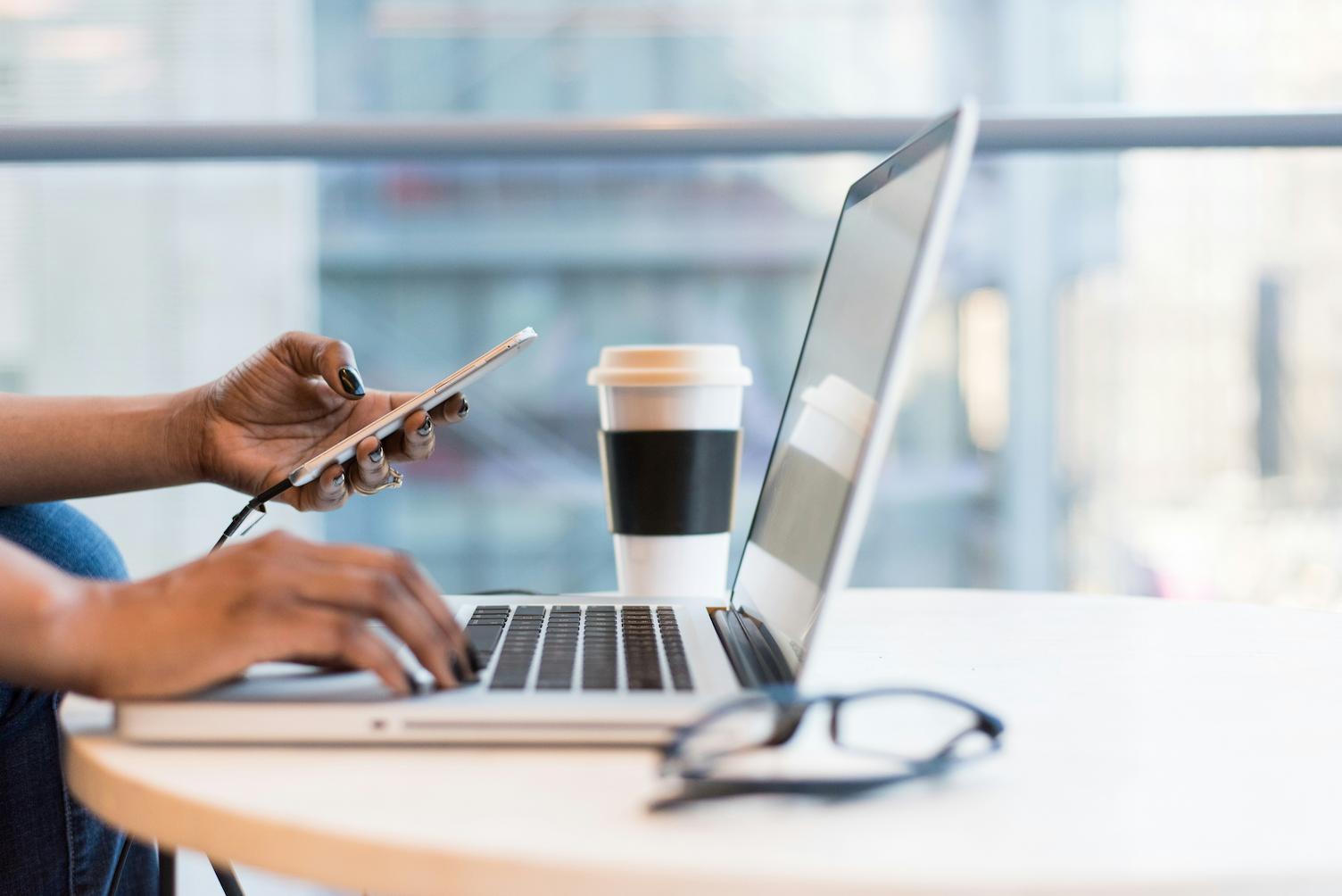 A woman working on her laptop, contacting a woman motivational speaker.