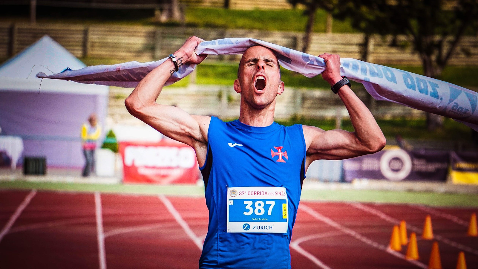 Athlete ripping the finish line strap.