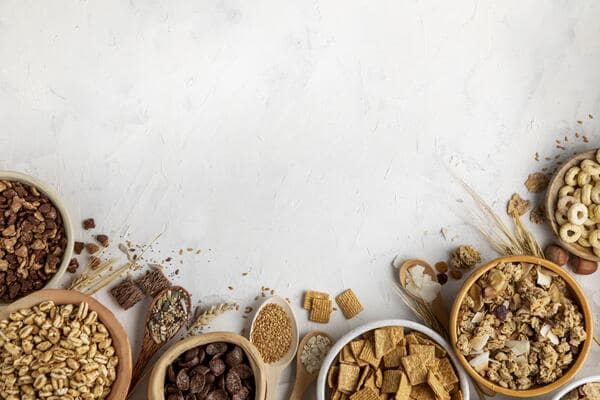 Different varieties of cereals served in individual wooden bowls