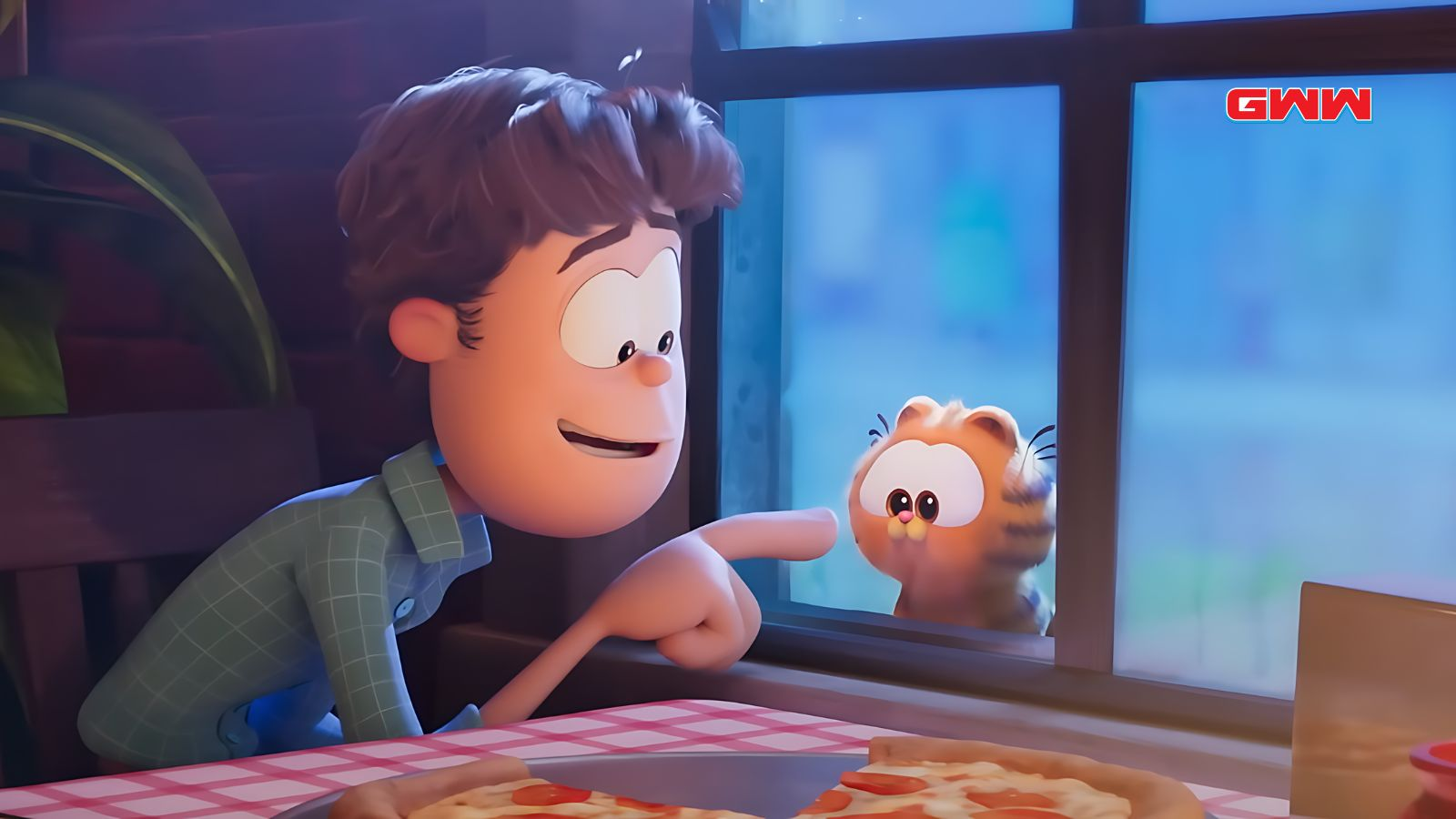 Jon Arbuckle smiling at small orange Garfield beside a pizza.