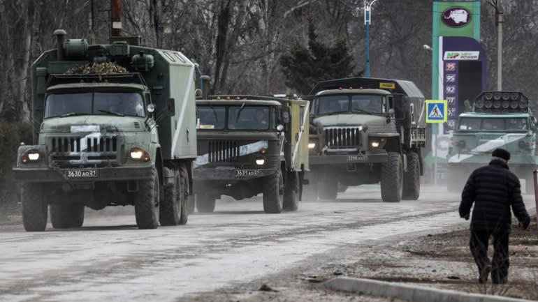 A group of military trucks on a road