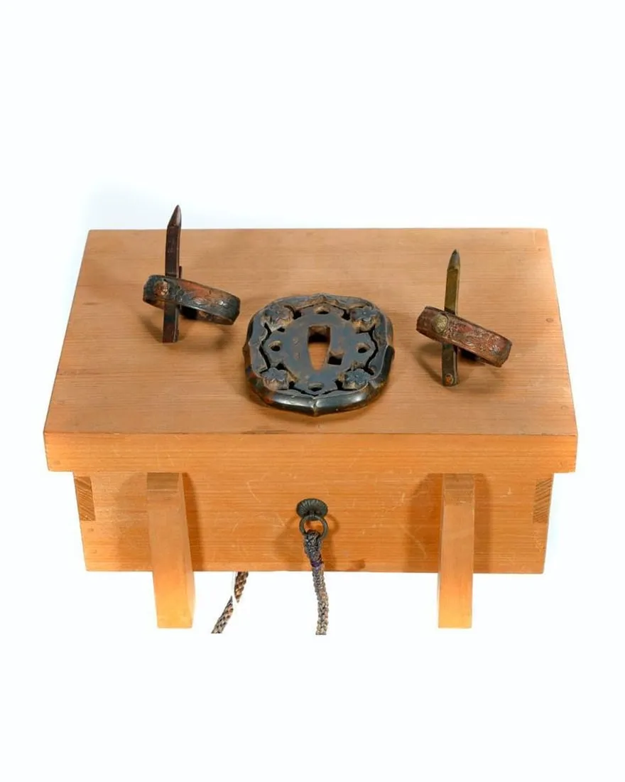 A wooden box with metal objects on topDescription automatically generated