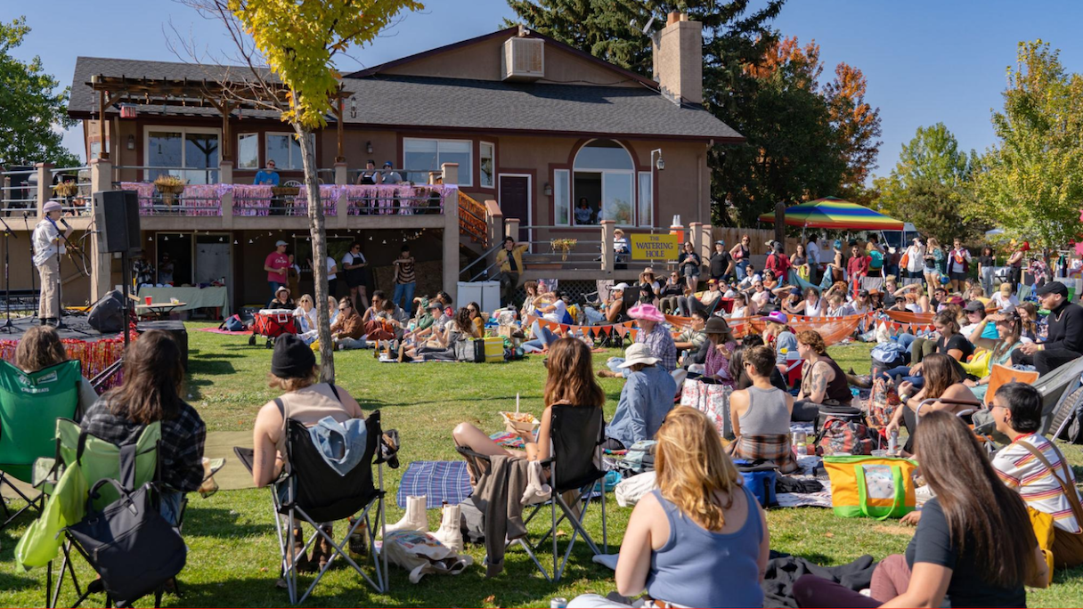 crowd sitting on grass